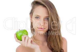 Pleased brunette model holding an apple