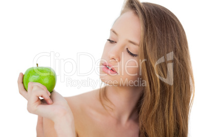 Thoughtful brunette model holding an apple