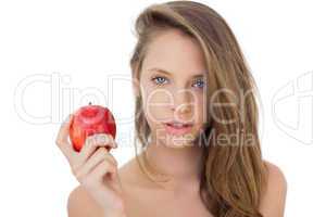Attractive brunette model holding an apple