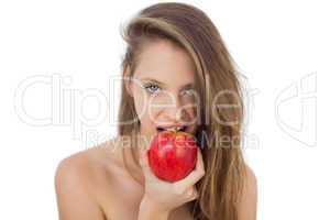 Pretty brunette model eating an apple