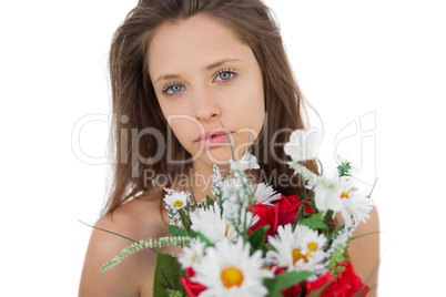 Calm brunette model holding a bouquet of flowers