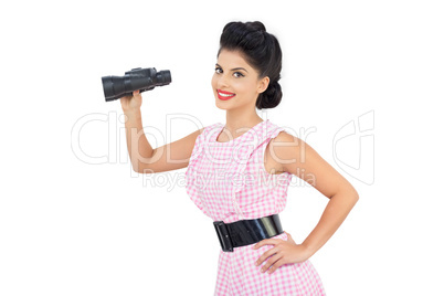 Smiling black hair model holding binoculars