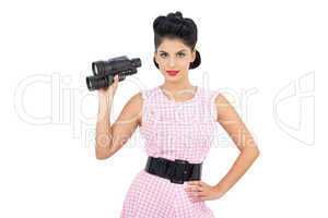 Pleased black hair model holding binoculars