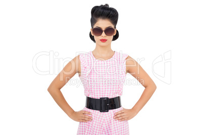 Unsmiling black hair model wearing glasses and posing hands on t