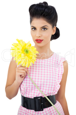 Gorgeous black hair model holding a flower