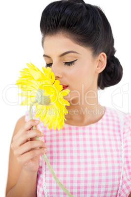 Gorgeous black hair model smelling a flower
