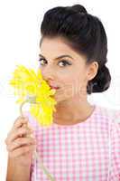 Seductive black hair model smelling a flower