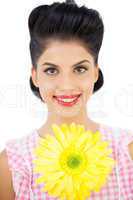 Smiling black hair woman showing a flower