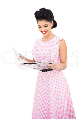 Smiling black hair model reading a magazine