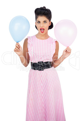 Amused black hair model holding balloons