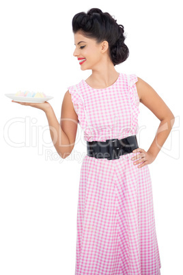 Happy black hair model looking at a plate of candies