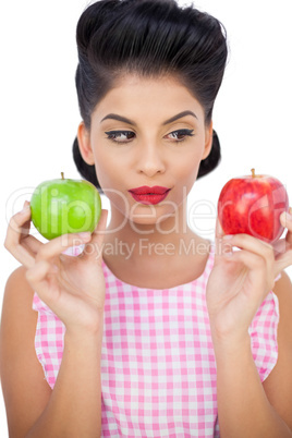 Pensive black hair model holding apples