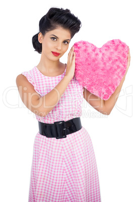 Cute black hair model holding a pink heart shaped pillow
