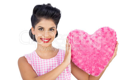 Lovely black hair model holding a pink heart shaped pillow