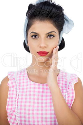 Serious black hair model posing with a hand on the cheek