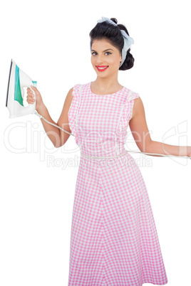 Smiling black hair model posing and holding an iron