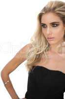 Gorgeous blonde model in black dress posing looking away