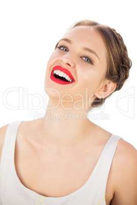 Cheerful model in white dress posing looking at camera