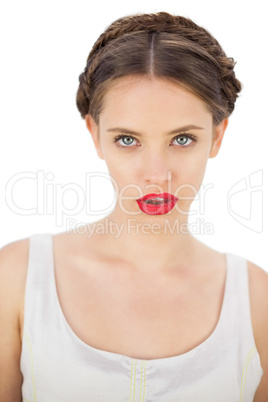 Calm model in white dress posing looking at camera