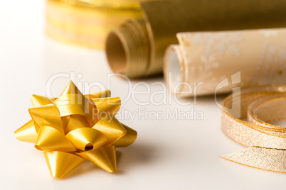 Golden wrapping paper and bow present decoration