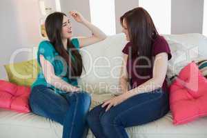 Two friends chatting on the sofa