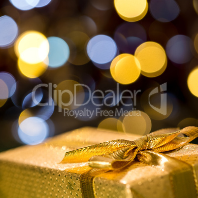 Christmas gift with sparkling lights background
