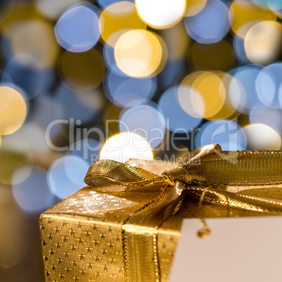 Christmas gift with label sparkling lights background