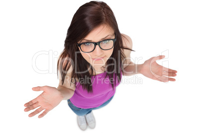 High angle view of uncertain brunette with glasses posing