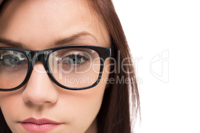 Close up on serious brunette with glasses posing