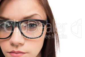 Close up on serious brunette with glasses posing