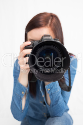 Casual young photographer taking picture of camera