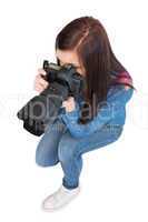 High angle view of casual young photographer taking picture