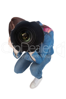 High angle view of young photographer taking picture of camera