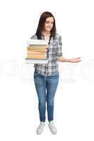 Smiling pretty student holding pile of books
