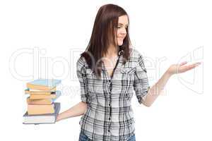 Happy pretty student holding pile of books
