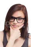 Thinking young woman wearing glasses posing