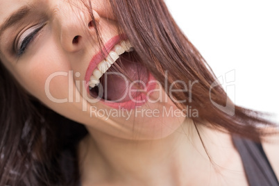 Close up on pretty brunette screaming