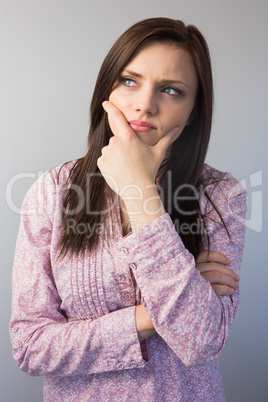 Thoughtful classy brunette posing