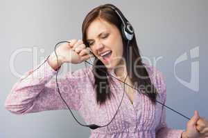 Smiling young brunette listening to music