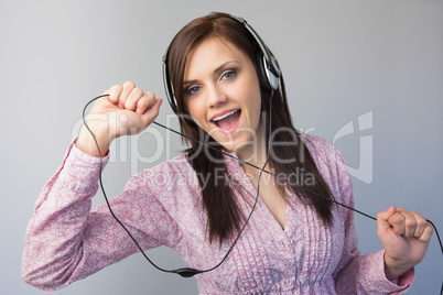 Cheerful young brunette listening to music