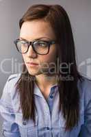 Thoughtful pretty brunette wearing glasses posing