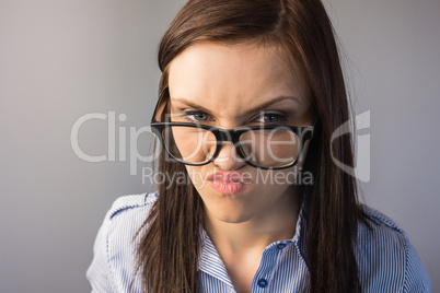Serious brunette with glasses making faces