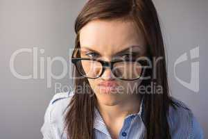 Serious brunette with glasses making faces