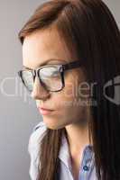 Day dreaming brunette with glasses posing