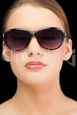 Classy blonde model wearing sunglasses