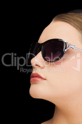 Pensive classy blonde wearing sunglasses