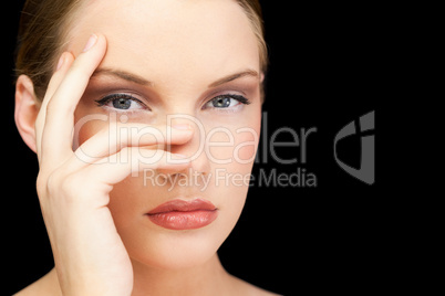 Glamorous young model posing hand on face
