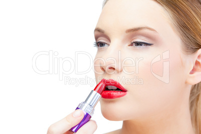 Glamorous blonde model applying red lipstick