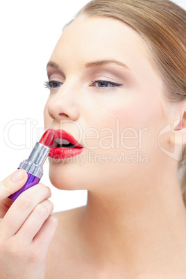 Glamorous blonde applying red lipstick