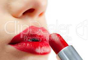 Extreme close up on red lips being made up